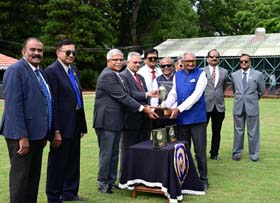 Mysore Race Club Steward H K Ramesh presenting the zmysore Summer Million Trophy to Mr K M Shah after his ward Pure For Sure won this event at Mysore on Wednesday.